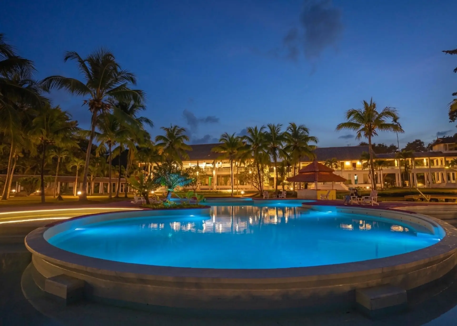 Aerial view of Bidong View Resort beachfront with pool and palm trees at sunset